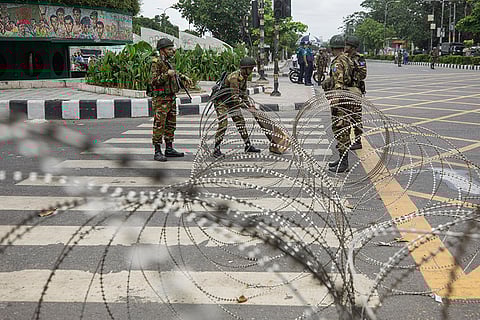 Soldiers set up barbed wires on road